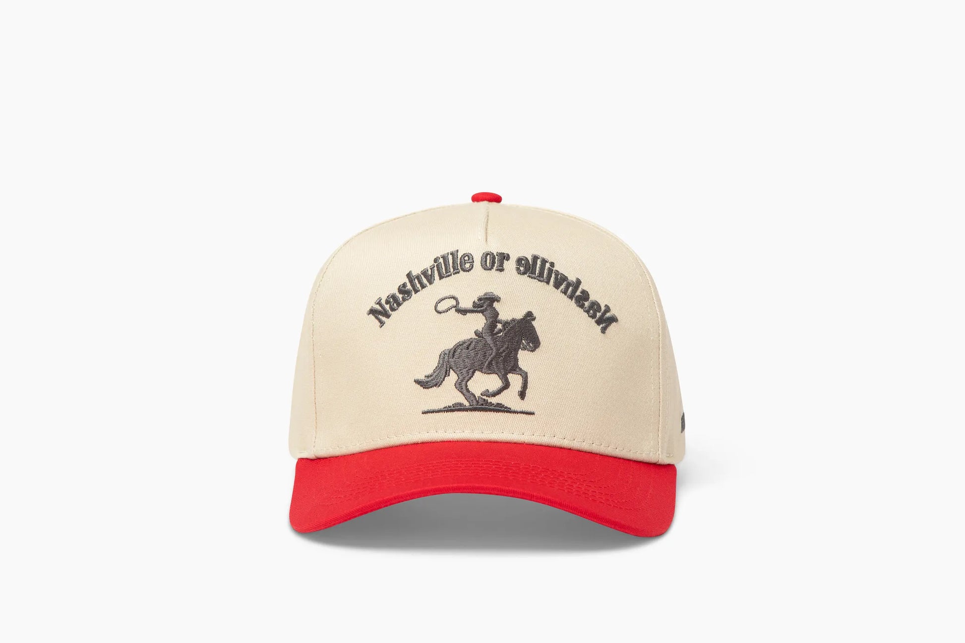 Front view of a beige baseball cap with a prominent red brim, showcasing "Nashville or Nashville" embroidered above a cowgirl riding a horse graphic.