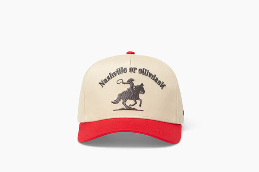 Front view of a beige baseball cap with a prominent red brim, showcasing "Nashville or Nashville" embroidered above a cowgirl riding a horse graphic.