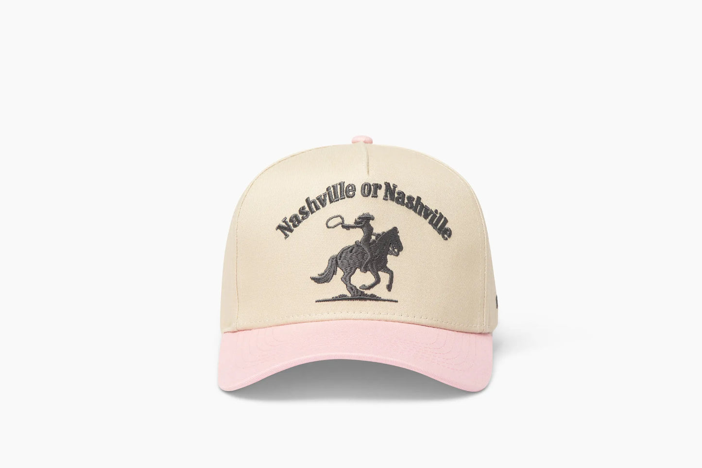 Front view of a beige baseball cap with a prominent pink brim, showcasing "Nashville or Nashville" embroidered above a cowgirl riding a horse graphic.