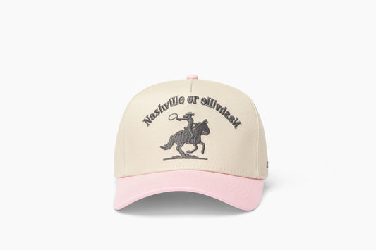 Front view of a beige baseball cap with a prominent pink brim, showcasing "Nashville or Nashville" embroidered above a cowgirl riding a horse graphic.