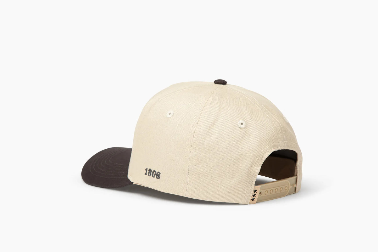 Beige baseball cap with gray brim, featuring "1806" embroidered on the back and three black star details on the adjustable strap. Back view.